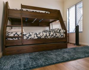 a bedroom with a bunk bed and a rug at Rockingham Beach Townhouse in Rockingham