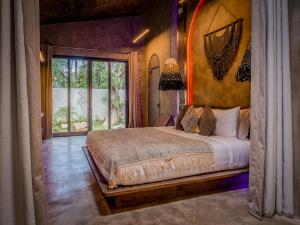 a bedroom with a large bed in a room at Diwatu Villas in El Nido +112 photos