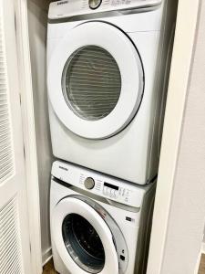 a washing machine and a dryer in a room at Cozy Modern 1 Bedroom Apartment in Davenport