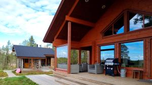 a log cabin with a grill on a deck at Villa Kanger in Kuusamo +31 photos