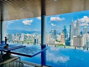 a swimming pool with a view of the city at The Luxe Colony KLCC by Sky Pool in Kuala Lumpur