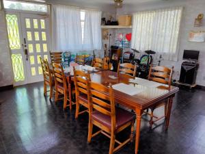 a dining room with a wooden table and chairs at Orange house Izu Simoda in Shimoda