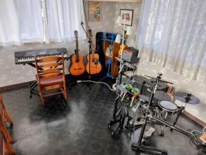 a music room with guitars and instruments in it at Orange house Izu Simoda in Shimoda
