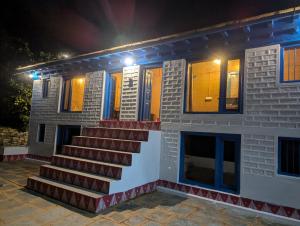 a house with stairs in front of it at night at Idyllic Haven Heritage, Jageshwar in Jageshwar