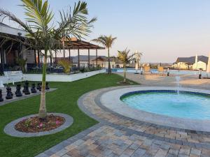 a swimming pool with a fountain in a yard at Ballito Hills unit 350 in Ballito