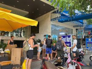 a group of people standing in front of a building at Waikiki Beach Hotel Da Nang in Da Nang