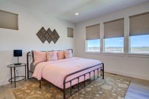 a bedroom with a bed with pink sheets and windows at Spacious 3BR Home - Perfect Belgrade Getaway in Belgrade +25 photos