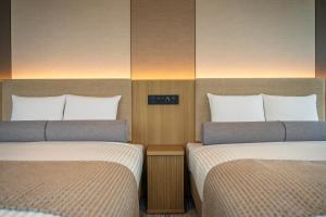 Postel nebo postele na pokoji v ubytování ART HOTEL Nippori Lungwood
