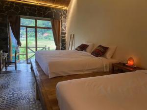 Postel nebo postele na pokoji v ubytování Ha Giang Ecolodge