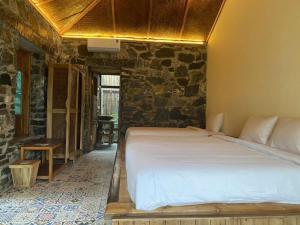 Postel nebo postele na pokoji v ubytování Ha Giang Ecolodge
