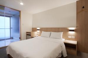 Postel nebo postele na pokoji v ubytování Nei Jiang Hotel