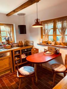 a kitchen with a wooden table and chairs in it at Walnußhof in Schmogrow