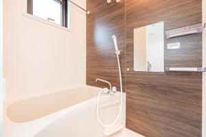 a bathroom with a bath tub and a sink at New-built APT at Asakusa-Skytree area with Tranquil block in Tokyo