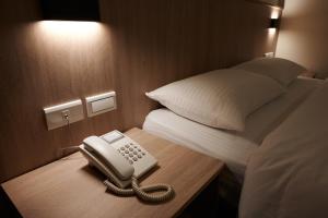 Postel nebo postele na pokoji v ubytování Nei Jiang Hotel