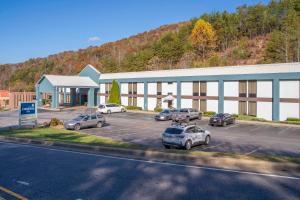 a large building with cars parked in a parking lot at Clarion Pointe Cherokee in Cherokee