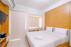 Ένα ή περισσότερα κρεβάτια σε δωμάτιο στο Simply Look Studio at Margonda Residence 5 Apartment By Travelio +5 φωτογραφίες