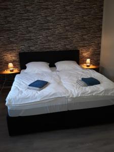 a large bed with two pillows on it with two lamps at Gasthaus Wagner in Rotenburg an der Fulda