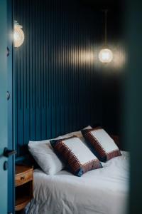 a bedroom with a bed with two pillows on it at La Mercerie "BedinShop" Centre Ville in Chartres +65 photos