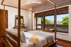 A bed or beds in a room at Jetwing Lagoon Wellness, A Luxury Reserve - Adults Only