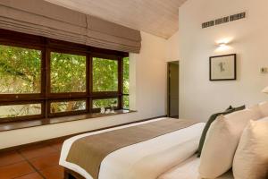 A bed or beds in a room at Jetwing Lagoon Wellness, A Luxury Reserve - Adults Only