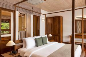 A bed or beds in a room at Jetwing Lagoon Wellness, A Luxury Reserve - Adults Only