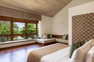 A bed or beds in a room at Jetwing Lagoon Wellness, A Luxury Reserve - Adults Only