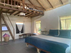 a bedroom with a large bed with blue sheets at Little Forest Chiang Mai in Chiang Mai