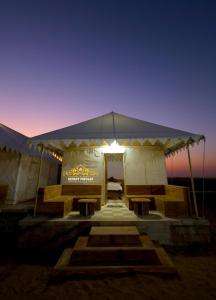 斋沙默尔Desert Popular Resort & Camp的帐篷,晚上配有一张床
