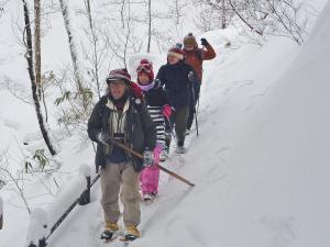 a group of people cross country skiing in the snow at Awone Shirakami Juniko in Fukaura