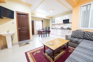 a living room with a couch and a table at Shine Homestay Famille Francophone - Shine Home and Apartment in Kathmandu