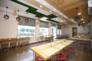 a dining room with wooden tables and chairs at Hotel O Platina in Mubārikpur