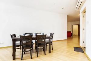 a dining room with a table and black chairs at 118 Island Plaza Penang in Tanjong Tokong