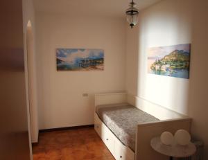 a bedroom with a bed and two paintings on the wall at Il Patio - Theater Home in Tignale