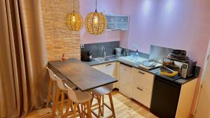 a small kitchen with a table and chairs in it at Le Crocolion in Arès