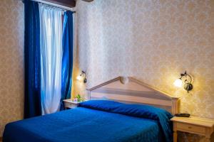 Ένα ή περισσότερα κρεβάτια σε δωμάτιο στο Hotel Tintoretto