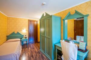 Ένα ή περισσότερα κρεβάτια σε δωμάτιο στο Hotel Tintoretto