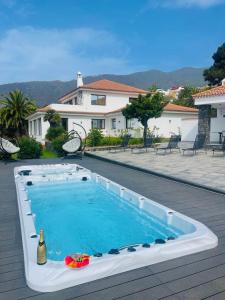 a swimming pool with a bottle of wine in it at Villa SOHLARA in La Orotava