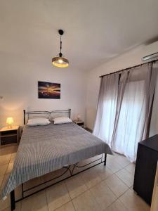 a bedroom with a bed and a tv in a room at D and D Home Alonissos in Alonnisos Old Town