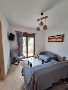 a living room with two couches and a table at D and D Home Alonissos in Alonnisos