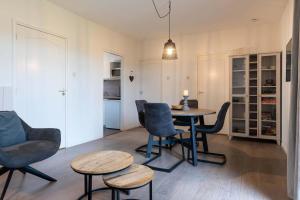 a living room with a table and chairs at Hello Zeeland - Apartment Noordstraat 30 in Zoutelande