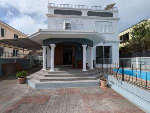 a large white house with a swimming pool at 3 BR Villa Agape with Pool in Tamarin
