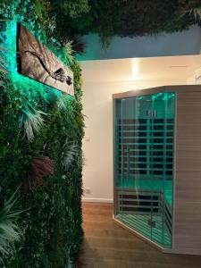 a room with a wall covered in plants at 90m2 hyper centre Sauna in Strasbourg