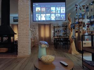 a living room with a tv and a table at La Cambra casa rural in Potríes