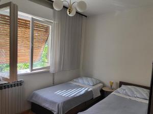 a bedroom with two beds and a window at Apartments with parking space Moscenicka Draga, Opatija - 2346 in Mošćenička Draga