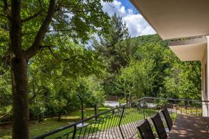a balcony with chairs and a view of trees at Apartments with parking space Moscenicka Draga, Opatija - 2346 in Mošćenička Draga