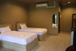 Letto o letti in una camera di Aomkod Erawan อ้อมกอดเอราวัณ