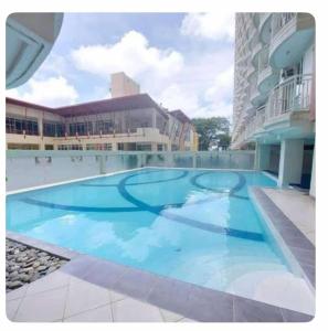 a large swimming pool in the middle of a building at Tagaytay Prime Residence City Land in Tagaytay
