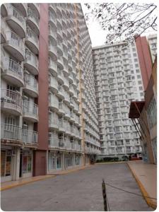 a large apartment building with balconies in a city at Tagaytay Prime Residence City Land in Tagaytay