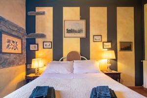 a bedroom with a large bed and two lamps at Casale Giaggiolo in Incisa in Valdarno