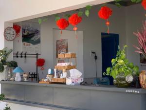a counter with red paper balls hanging above it at Nomad Stay in Phan Rang–Tháp Chàm